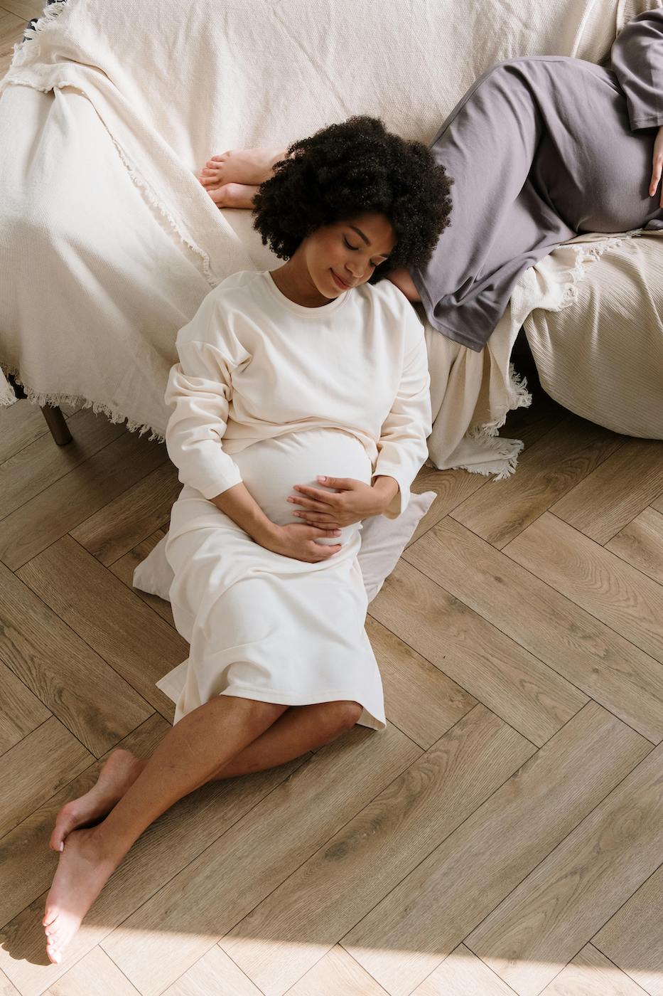 Woman With Hands Over Pregnant Belly - Connecting to Body And Womb