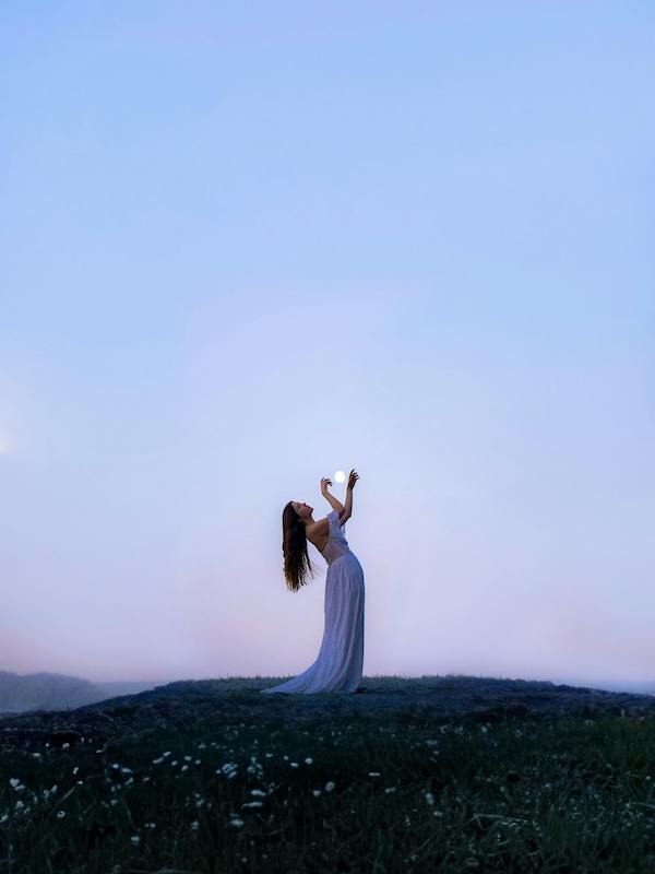 Woman posing with the moon